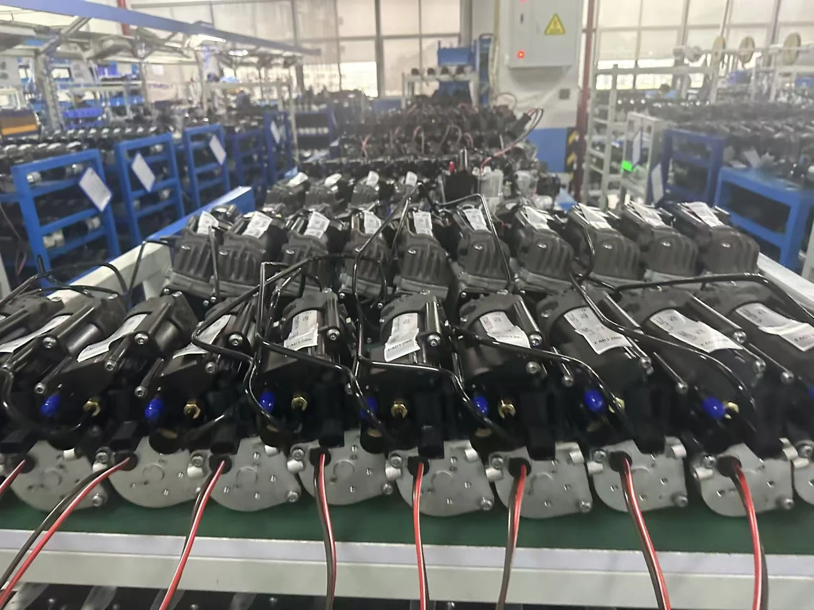 Air suspension compressor assemblies on a workshop bench